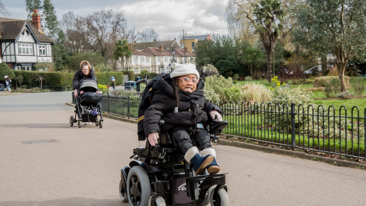Kiyo-Rei whizzes along a park path in her powered chair