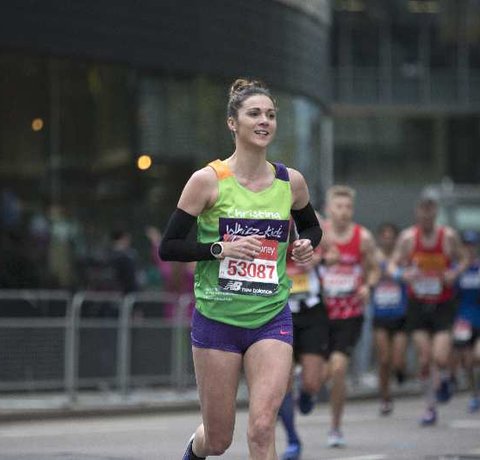 A runner in a green Whizz Kidz top during the London Marathon